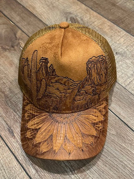 Brown embroidered cap on a wooden surface