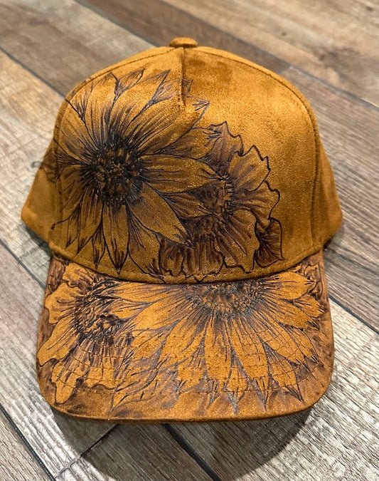 Brown cap with floral designs on a wooden surface