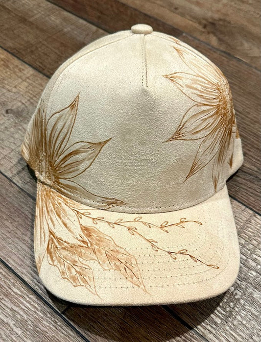 Beige cap with leaf designs on a wooden surface