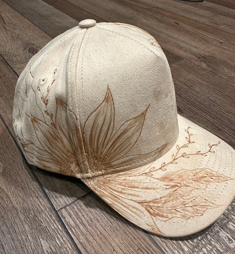Beige cap with floral design on a wooden floor