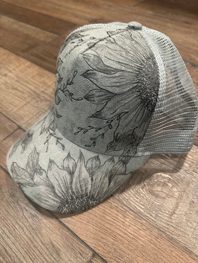 Trucker hat with floral design on a wooden floor