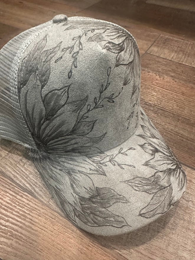Gray cap with floral patterns on a wooden surface