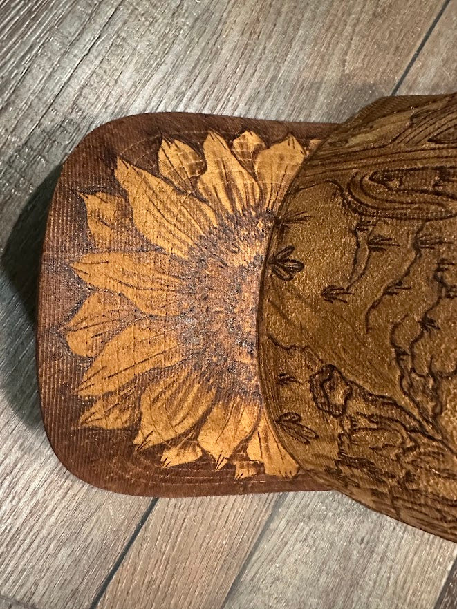 Wooden cookie cutters with floral designs on a wooden surface