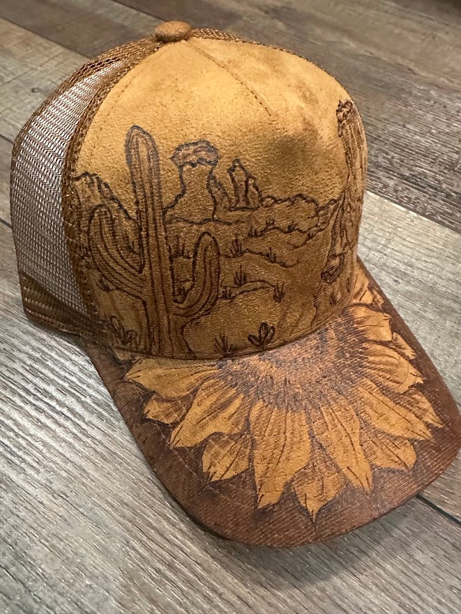 Brown leather cap with embossed designs on a wooden surface