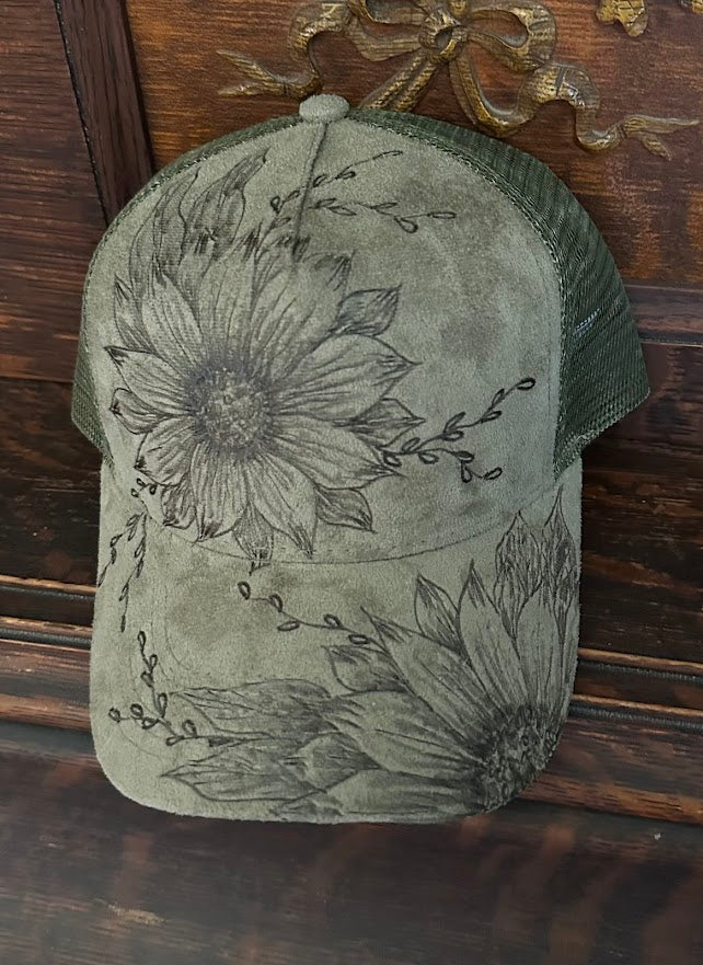 Green cap with floral designs on a wooden surface