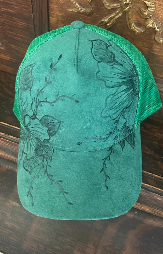 Green cap with butterfly design on a wooden surface