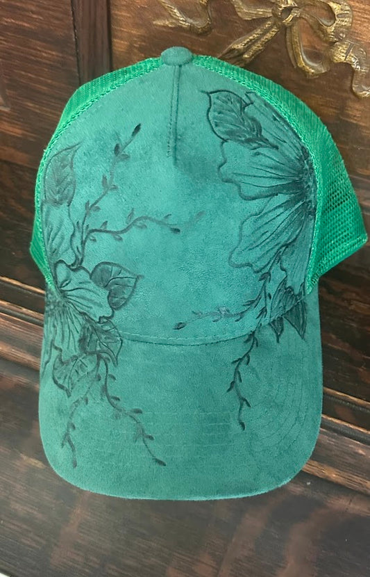 Green cap with butterfly design on a wooden surface