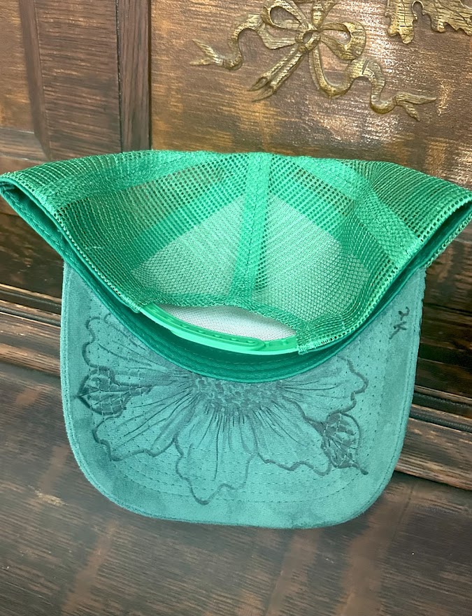 Green mesh bag with floral design on a wooden surface