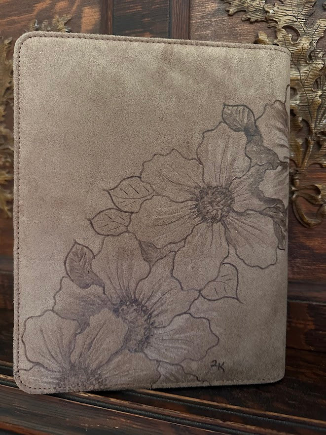 Floral-patterned leather case on a wooden surface