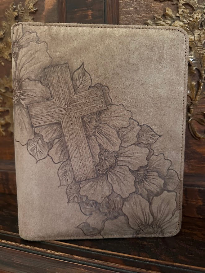 Decorative case with cross and floral design on a wooden surface