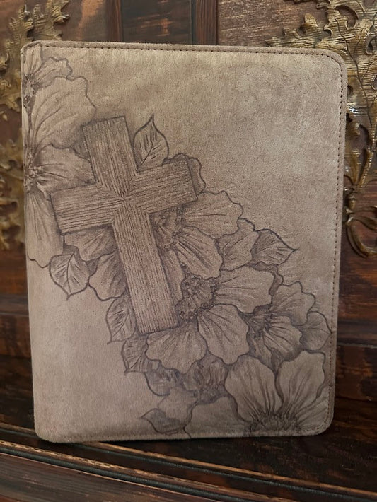 Decorative case with cross and floral design on a wooden surface