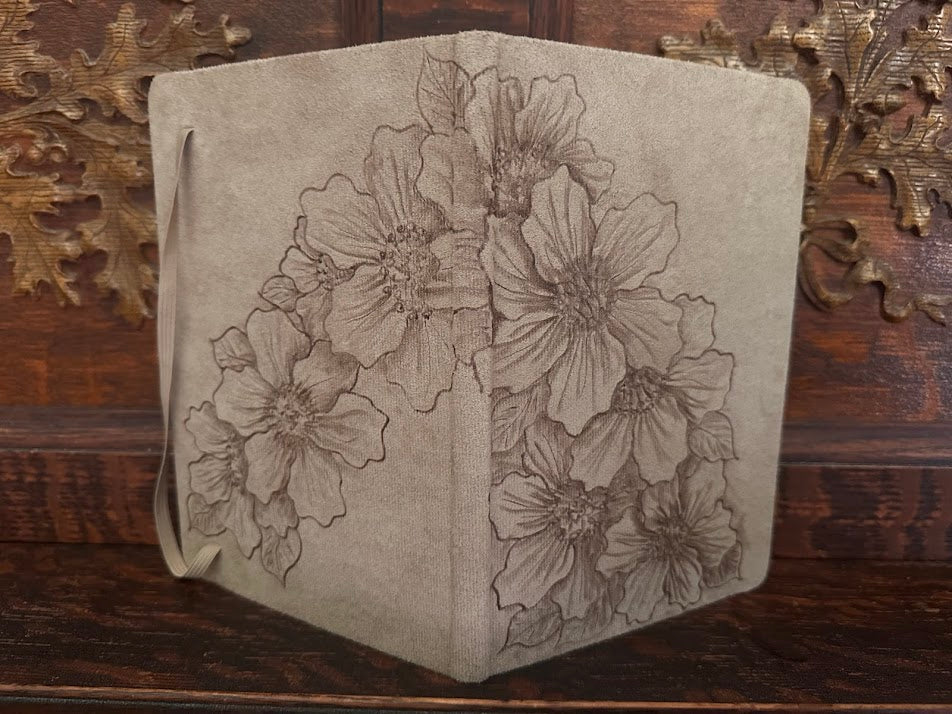 Floral embossed leather wallet on a wooden surface