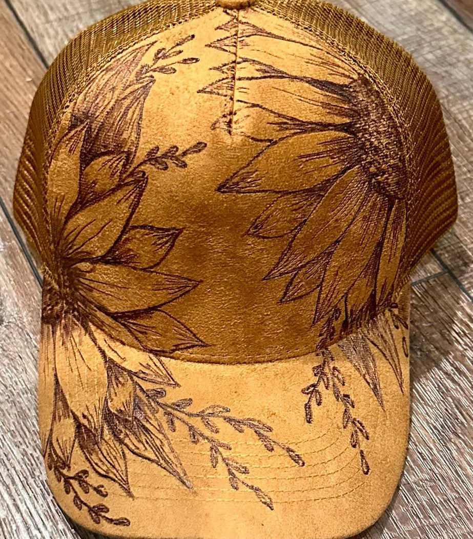 Brown cap with floral embroidery on a wooden surface