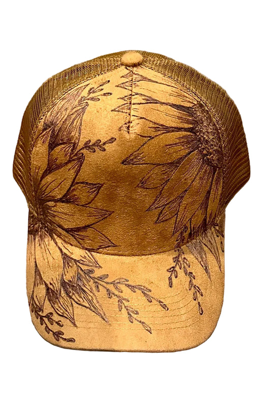 Brown cap with floral embroidery on a wooden surface
